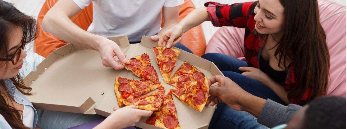 Students sharing a takeaway pizza