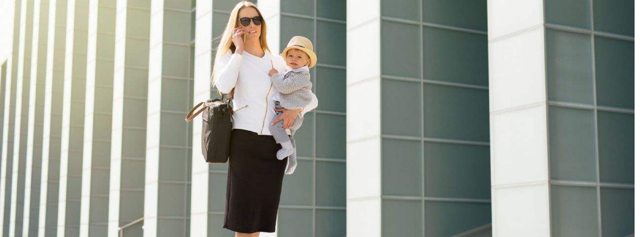 Woman with baby outside place of work